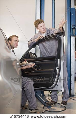 Mechanics working in garage View Large Photo Image Stock Photograph - Mechanics working in garage. Fotosearch