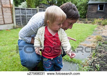 Mother and daughter exploring backyard View Large Photo Image Stock Image - Mother and daughter exploring backyard. Fotosearch