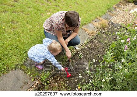 Mother and daughter gardening View Large Photo Image Stock Photo - Mother and daughter gardening. Fotosearch