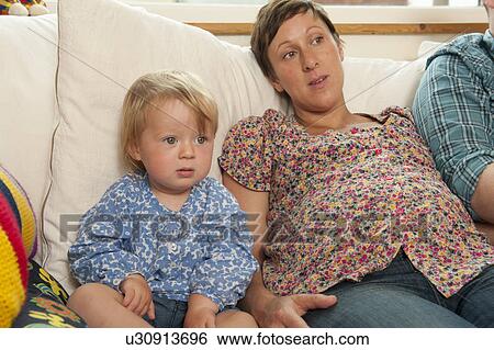 Mother and daughter watching television View Large Photo Image Stock Photograph - Mother and daughter watching television. Fotosearch