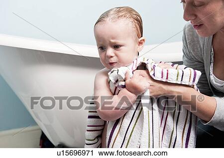 Mother toweling off toddler in bathroom View Large Photo Image Stock Image - Mother toweling off toddler in bathroom. Fotosearch