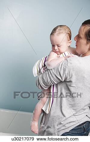 Stock Photo - Mother toweling off toddler in bathroom. Fotosearch