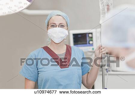 Nurse in facemask in operating room View Large Photo Image Stock Photo - Nurse in facemask in operating room. Fotosearch