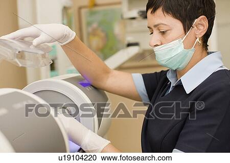 Nurse in facemask preparing equipment View Large Photo Image Stock Image - Nurse in facemask preparing equipment. Fotosearch