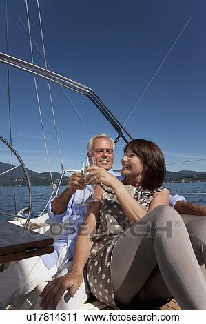 Older couple having champagne on boat View Large Photo Image Stock Image - Older couple having champagne on boat. Fotosearch