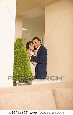 Older couple hugging in lobby area View Large Photo Image Stock Photo - Older couple hugging in lobby area. Fotosearch