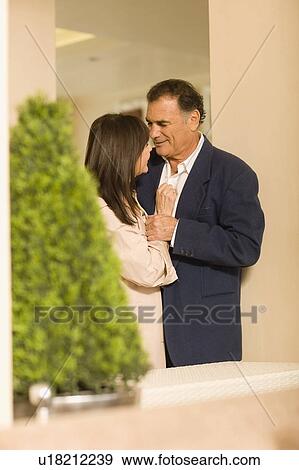 Older couple hugging in lobby area View Large Photo Image Stock Photo - Older couple hugging in lobby area. Fotosearch
