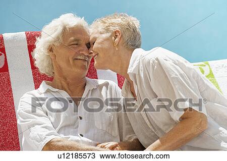 Older couple hugging outdoors View Large Photo Image Stock Image - Older couple hugging outdoors. Fotosearch