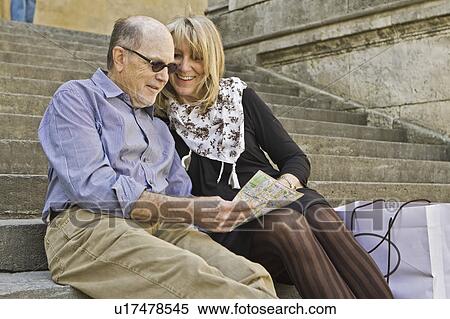 Older couple reading city map on steps View Large Photo Image Stock Photography - Older couple reading city map on steps. Fotosearch