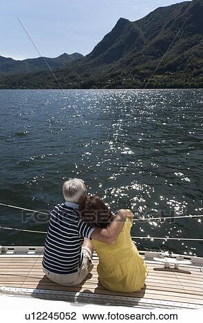 Older couple relaxing on sailboat View Large Photo Image Stock Image - Older couple relaxing on sailboat. Fotosearch