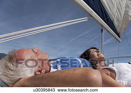 Older couple relaxing on sailboat View Large Photo Image Stock Image - Older couple relaxing on sailboat. Fotosearch