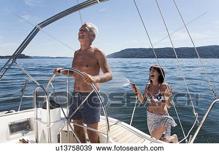 Older couple relaxing on sailboat View Large Photo Image Stock Photo - Older couple relaxing on sailboat. Fotosearch