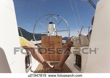 Older couple relaxing on sailboat View Large Photo Image Stock Photo - Older couple relaxing on sailboat. Fotosearch