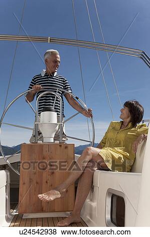 Older couple relaxing on sailboat View Large Photo Image Stock Photo - Older couple relaxing on sailboat. Fotosearch