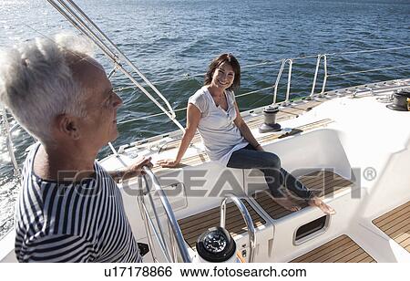 Older couple relaxing on sailboat View Large Photo Image Stock Photograph - Older couple relaxing on sailboat. Fotosearch