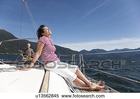 Older couple relaxing on sailboat View Large Photo Image Stock Photography - Older couple relaxing on sailboat. Fotosearch