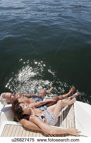 Older couple relaxing on sailboat View Large Photo Image Stock Photography - Older couple relaxing on sailboat. Fotosearch