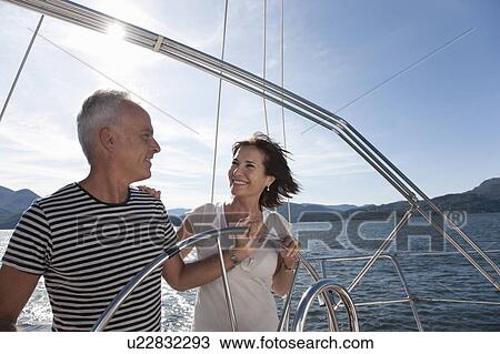 Stock Image - Older couple sailing together. Fotosearch