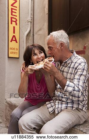 Older couple sharing pizza outdoors View Large Photo Image Stock Photography - Older couple sharing pizza outdoors. Fotosearch