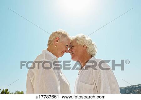 Older couple touching noses outdoors View Large Photo Image Stock Image - Older couple touching noses outdoors. Fotosearch