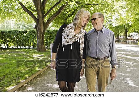 Older couple walking hand-in-hand View Large Photo Image Stock Photo - Older couple walking hand-in-hand. Fotosearch