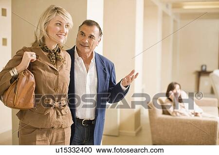 Older couple walking in lobby area View Large Photo Image Stock Image - Older couple walking in lobby area. Fotosearch