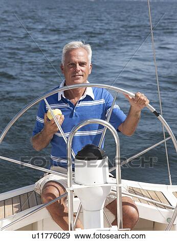 Older man sailing on lake View Large Photo Image Stock Photo - Older man sailing on lake. Fotosearch