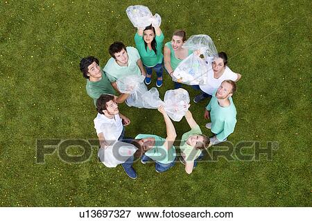 People holding garbage bags on grass View Large Photo Image Stock Photo - People holding garbage bags on grass. Fotosearch