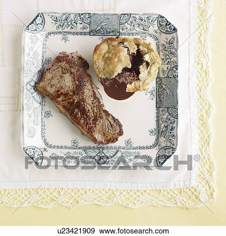Stock Photo - Plate of steak with mushroom pudding. Fotosearch