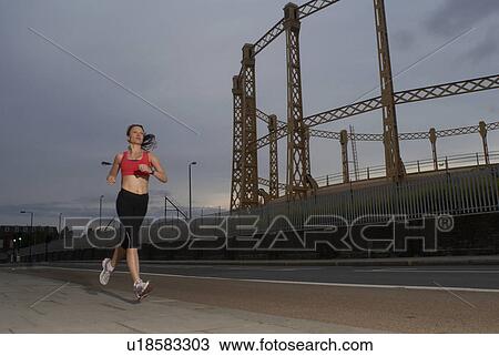 Runner jogging on city street View Large Photo Image Stock Image - Runner jogging on city street. Fotosearch
