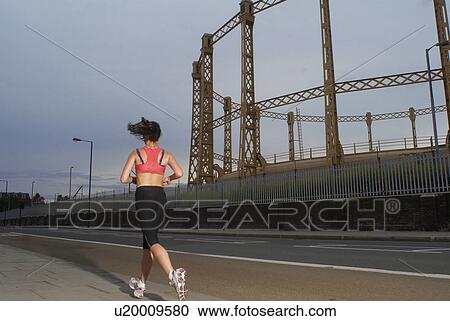 Stock Image - Runner jogging on city street. Fotosearch