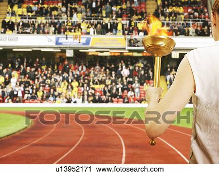 Runner on track with flaming baton View Large Photo Image Stock Image - Runner on track with flaming baton. Fotosearch
