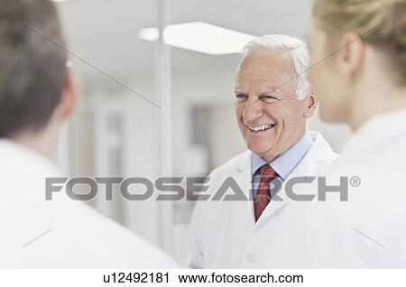 Stock Image - Scientist smiling in pathology lab. Fotosearch