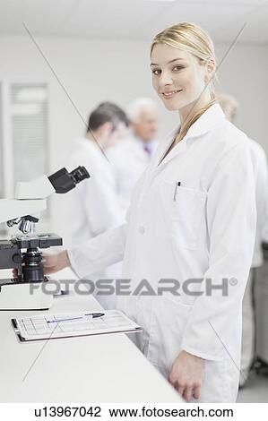 Stock Image - Scientist working in pathology lab. Fotosearch