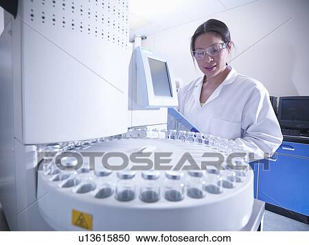 Scientist working on equipment in lab View Large Photo Image Stock Image - Scientist working on equipment in lab. Fotosearch