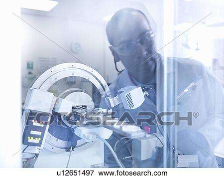 Scientist working with equipment in lab View Large Photo Image Stock Photo - Scientist working with equipment in lab. Fotosearch