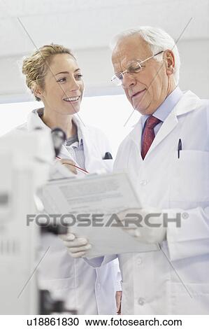 Scientists talking in pathology lab View Large Photo Image Stock Image - Scientists talking in pathology lab. Fotosearch