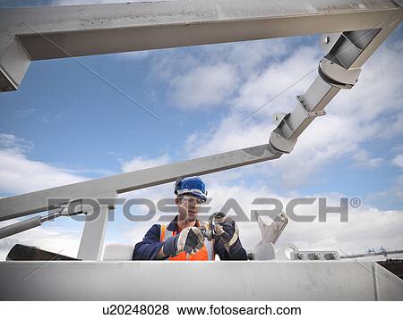 Shipbuilder working on lifeboat View Large Photo Image Stock Photo - Shipbuilder working on lifeboat. Fotosearch