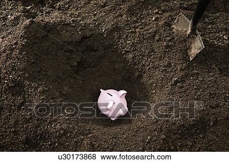 Shovel digging up piggy bank View Large Photo Image Stock Photo - Shovel digging up piggy bank. Fotosearch