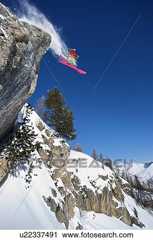 Skier in midair on snowy mountain View Large Photo Image Stock Image - Skier in midair on snowy mountain. Fotosearch