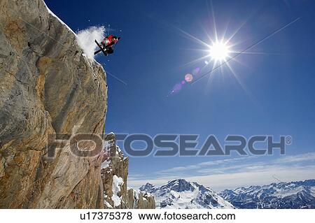 Stock Photo - Skier in midair on snowy mountain. Fotosearch