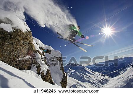 Skier in midair on snowy mountain View Large Photo Image Stock Photography - Skier in midair on snowy mountain. Fotosearch