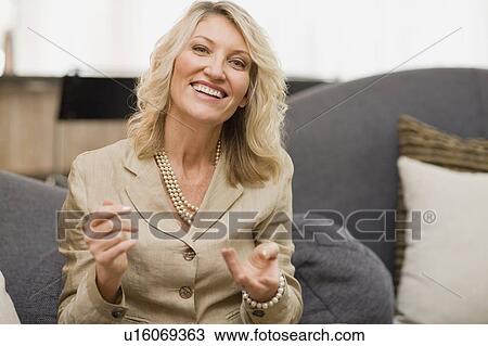 Smiling businesswoman talking on couch View Large Photo Image Stock Image - Smiling businesswoman talking on couch. Fotosearch