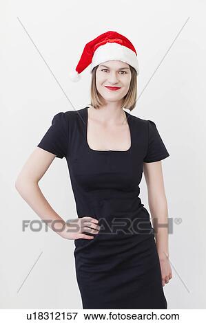 Smiling businesswoman wearing Santa hat View Large Photo Image Stock Photo - Smiling businesswoman wearing Santa hat. Fotosearch