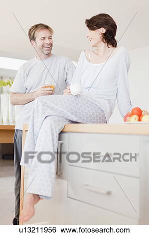 Smiling couple having breakfast View Large Photo Image Stock Photograph - Smiling couple having breakfast. Fotosearch