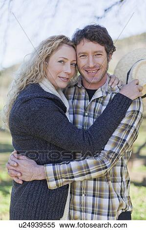 Smiling couple hugging outdoors View Large Photo Image Stock Photography - Smiling couple hugging outdoors. Fotosearch