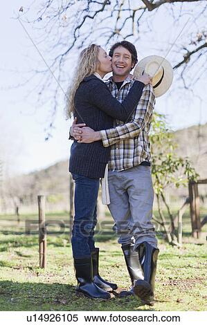 Stock Photography - Smiling couple kissing outdoors. Fotosearch