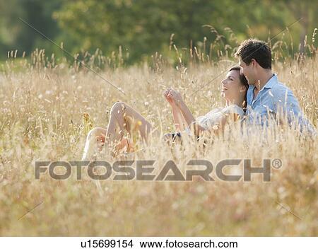 Smiling couple relaxing in wheatfield View Large Photo Image Picture - Smiling couple relaxing in wheatfield. Fotosearch
