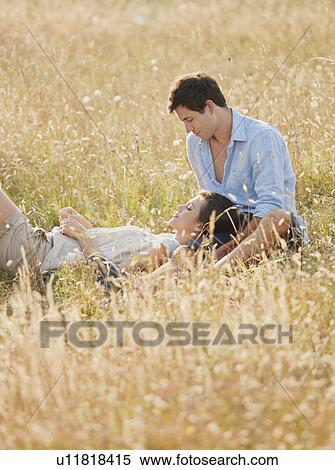 Smiling couple relaxing in wheatfield View Large Photo Image Stock Photography - Smiling couple relaxing in wheatfield. Fotosearch