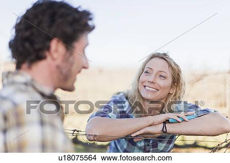 Smiling couple talking outdoors View Large Photo Image Picture - Smiling couple talking outdoors. Fotosearch